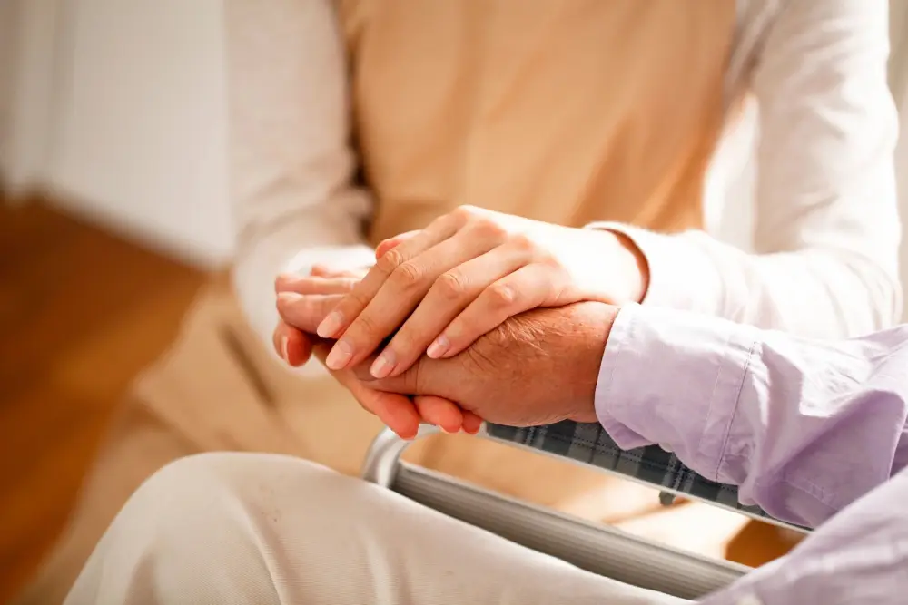 Two people holding hands in a room.