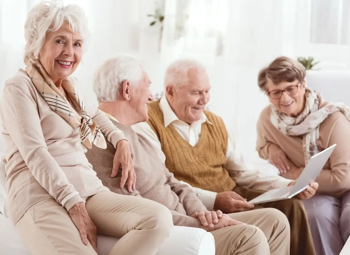 A group of people sitting around each other.